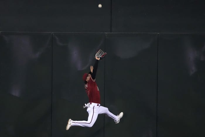 Alek Thomas makes a leaping catch agains the wall